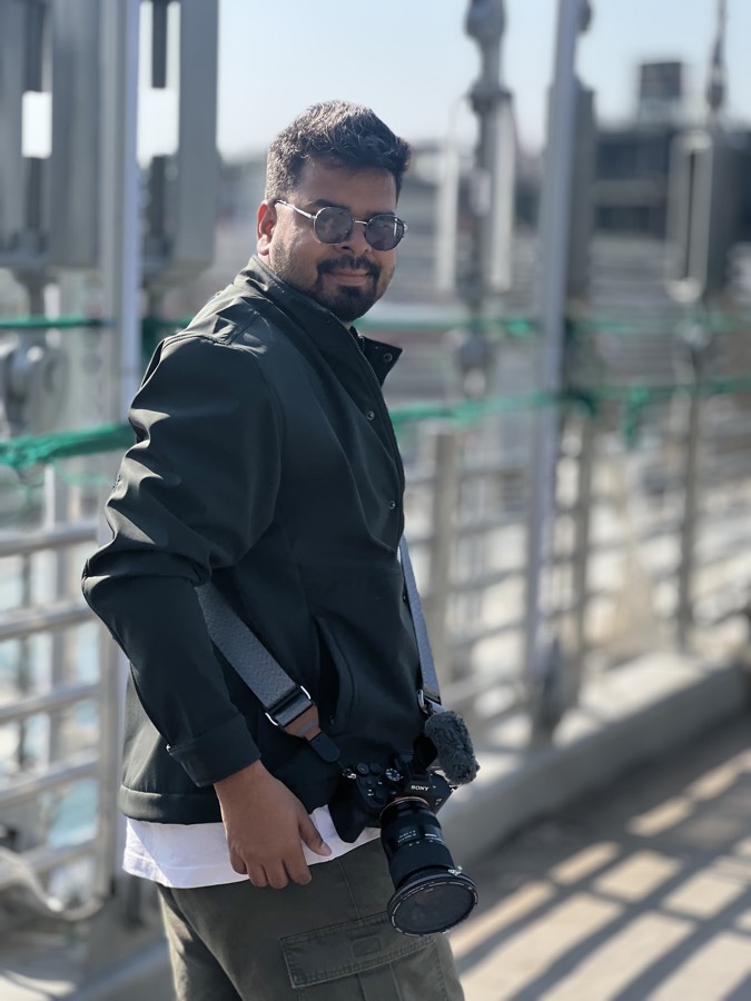 Saket with his camera on a rooftop