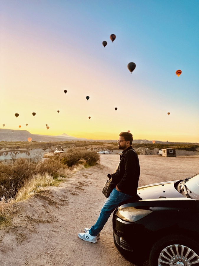 Saket at sunrise with hot air balloons in the sky