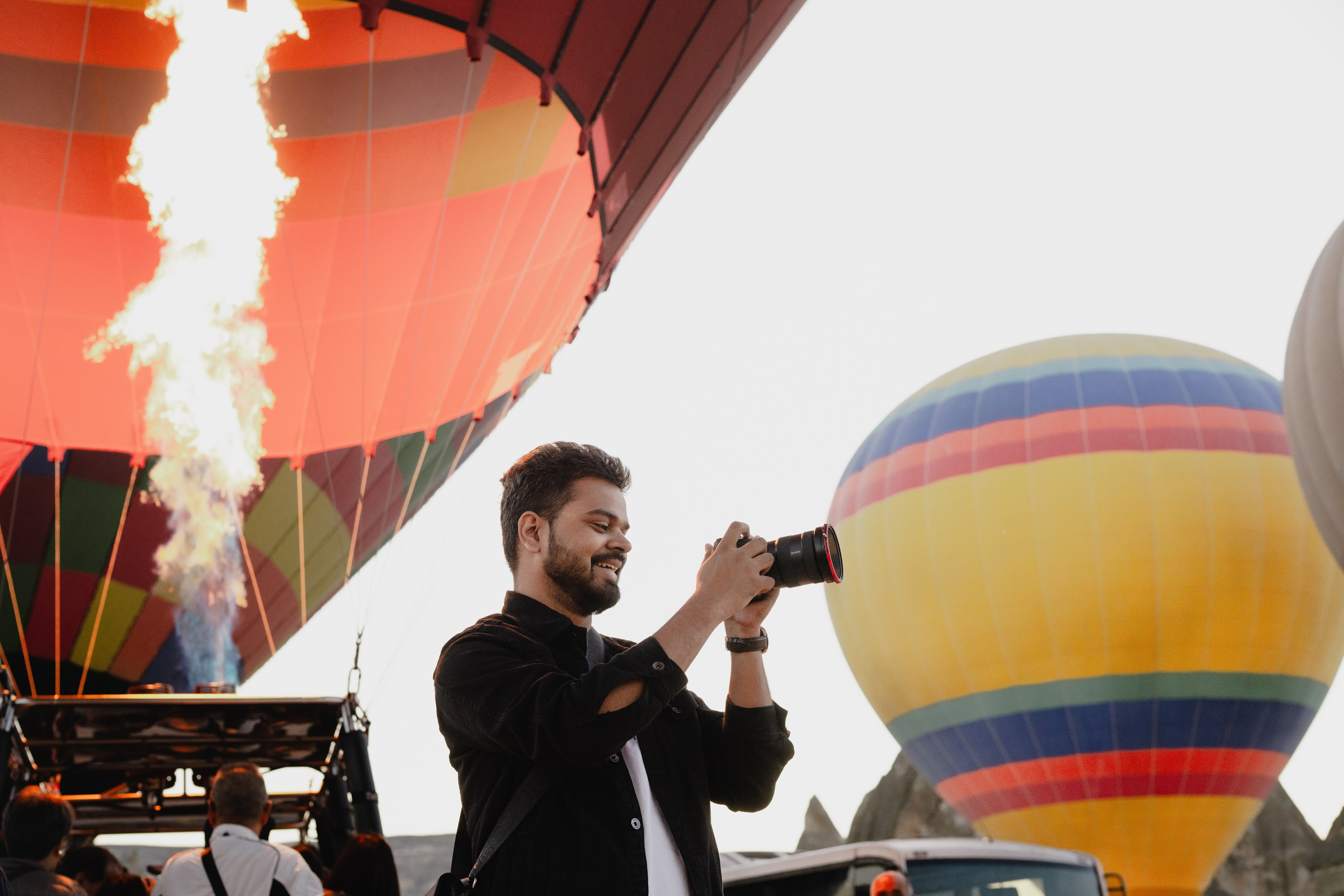 Saket Mishra walking beside a poolside colonnade during a destination shoot
